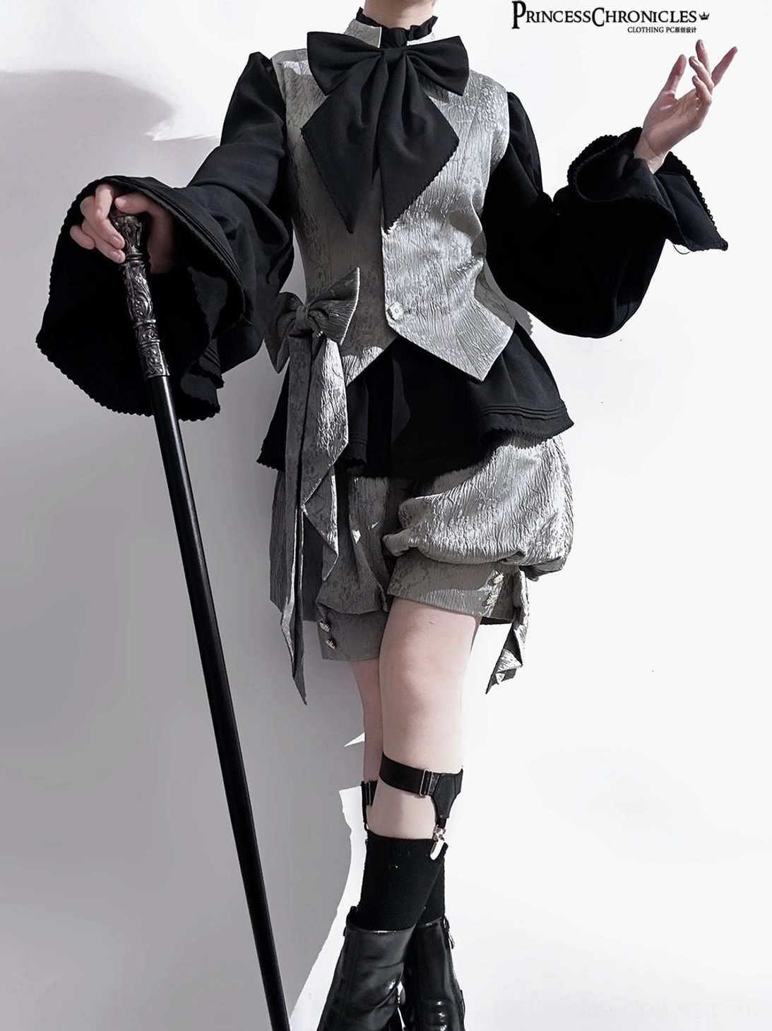 Rabbit ear ouji lolita grey textured coat three-quarter front view tied waist sash black bow necktie with walking cane prop