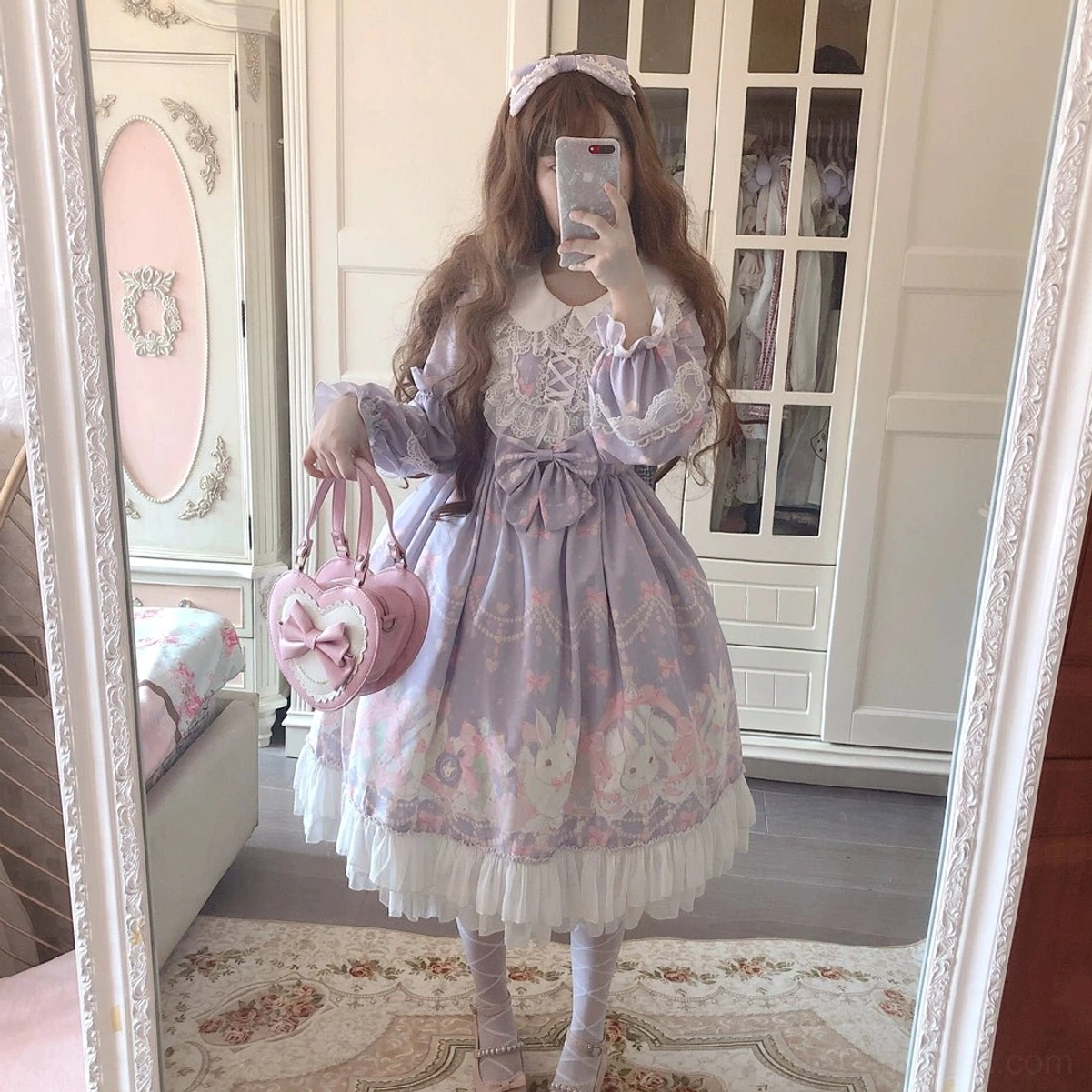 Sweet Lolita girl in pastel purple rabbit print one-piece dress with long puffed sleeves, lace-up bodice, ruffled skirt hem, wearing rabbit print headband, mirror selfie front pose