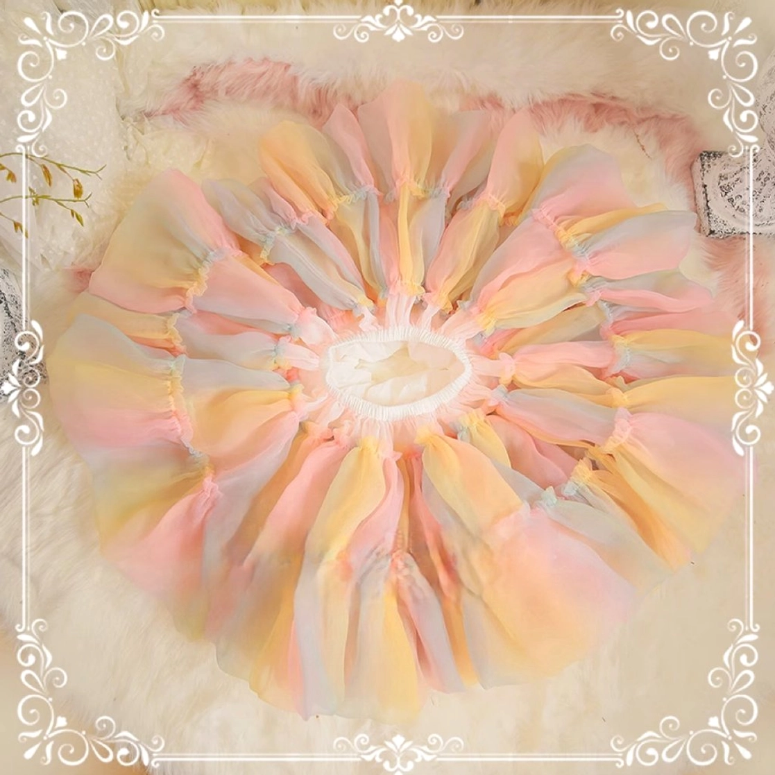 Top-down flat lay view of rainbow lolita petticoat fully spread, displaying complete circular silhouette with central elastic waistband and radial gathered tulle segments