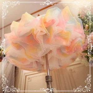 Close-up detail of lolita petticoat hem and ruffles, showcasing layered airy tulle construction with soft pastel color gradient and fluffy texture