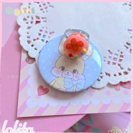 Raspberry cake lolita ring design in vibrant candy colors with decorative beads on glossy resin base