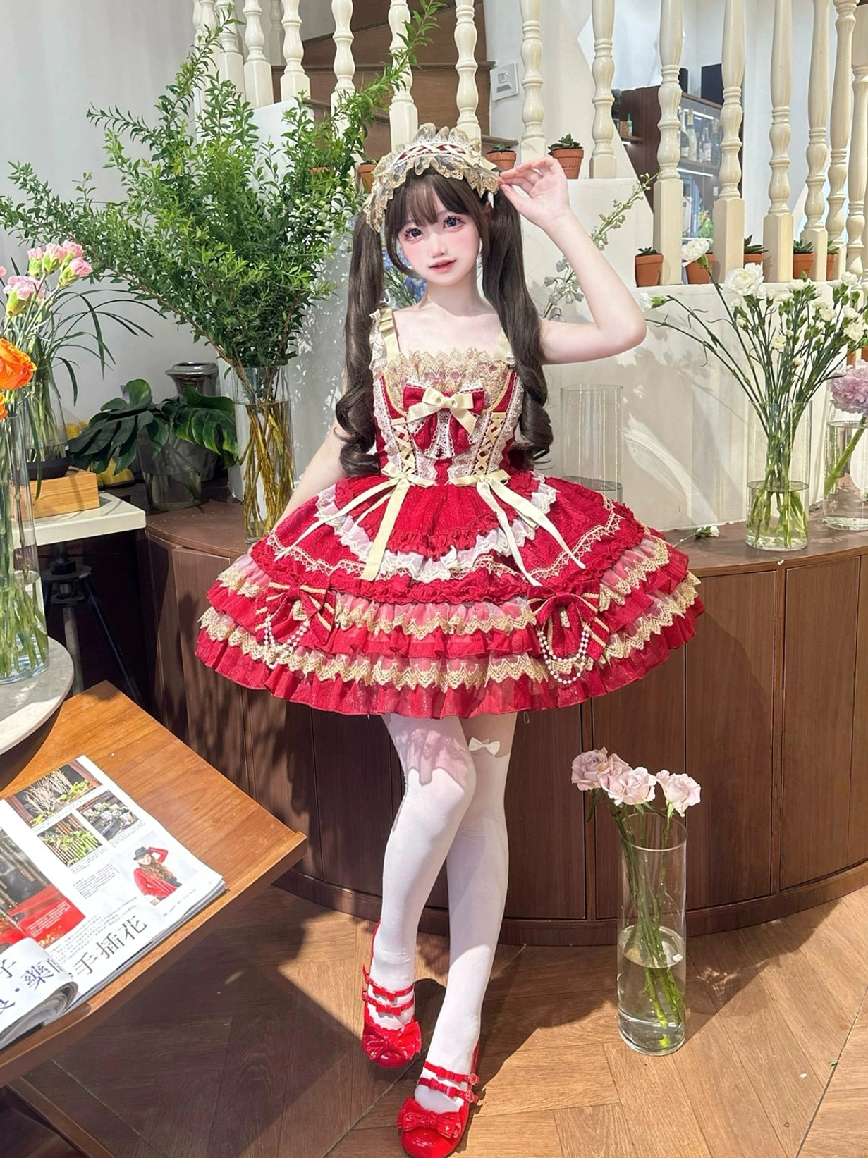 Red and gold sweet lolita jumper dress front three-quarter view tiered ruffled A-line skirt gold lace edging satin bow decorations pearl hanging details