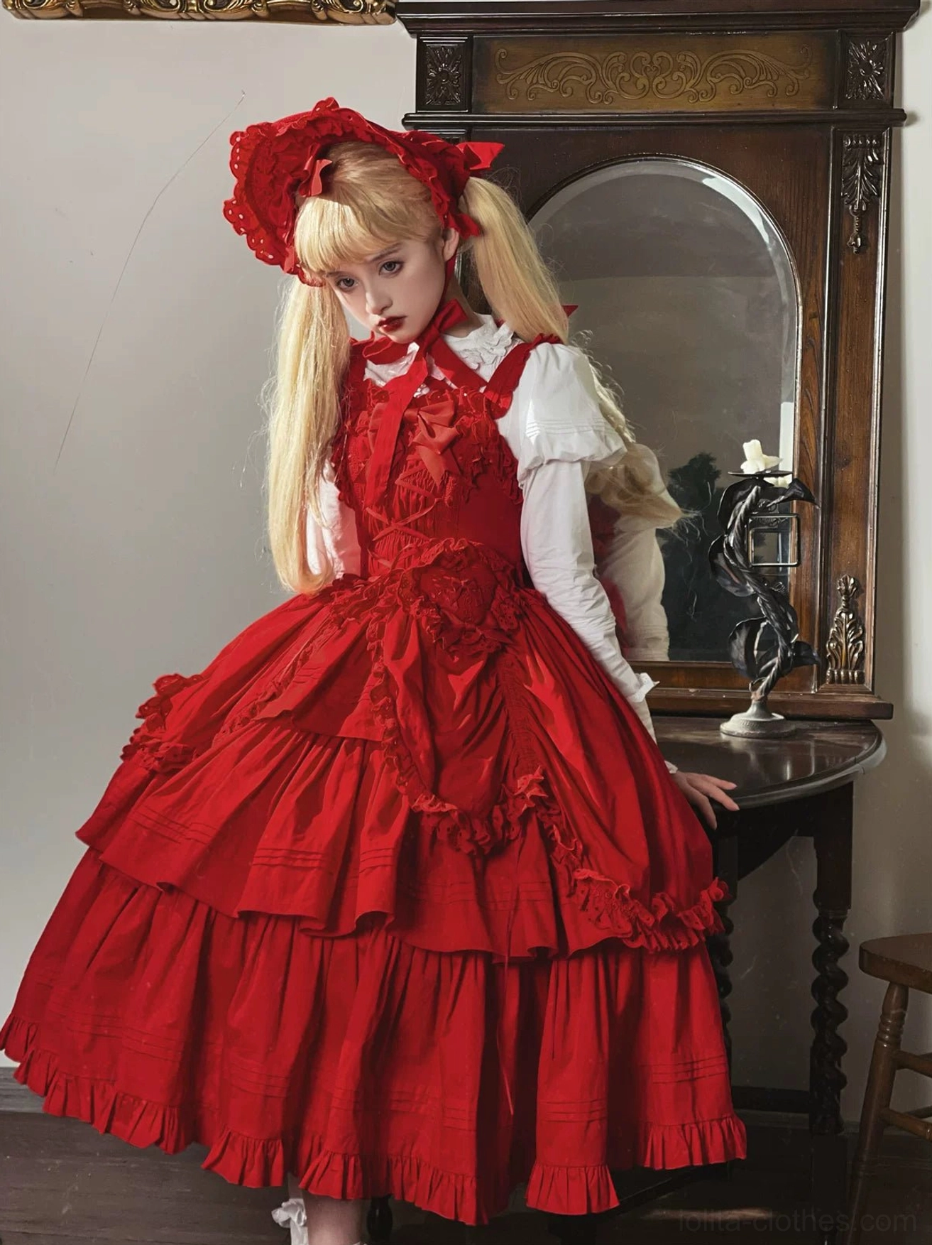 Front full-body mannequin shot of red Gothic Lolita JSK with tiered ruffled skirt, bow applique on bodice, and bright red satin fabric