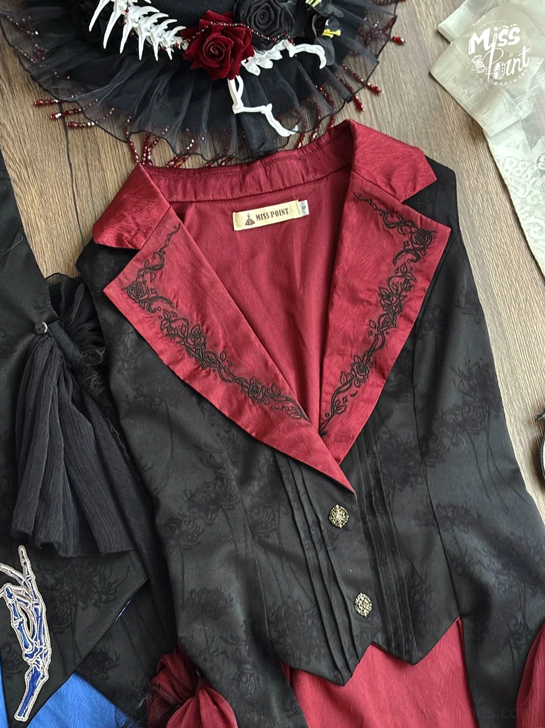 Red Gothic Lolita vest with satin lapel and intricate vine embroidery detail flat lay