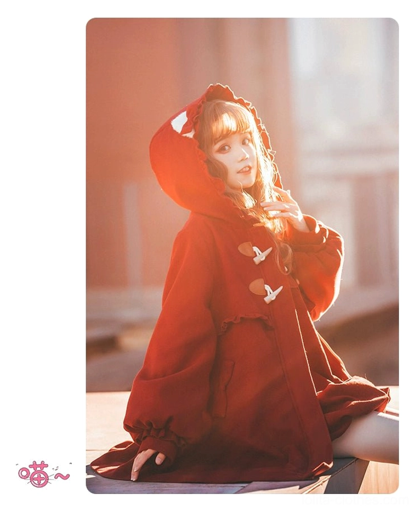 Red hooded lolita winter coat three quarter side sitting view model with hood up warm outdoor lighting horn toggle oversized loose fit mid length hem