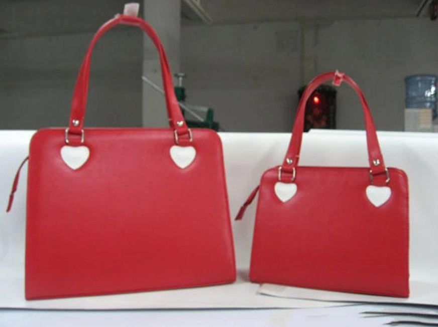 Pair of solid red minimalist lolita handbags with heart metal fixtures simple square tote design