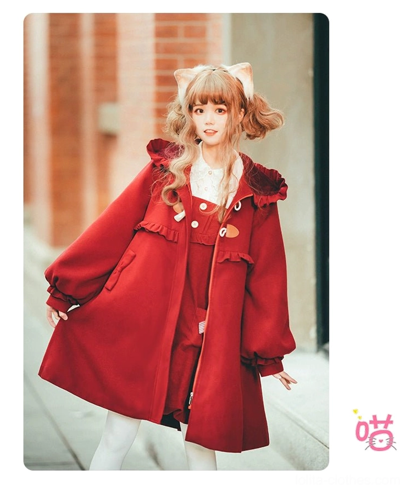 Red lolita winter coat three quarter front standing view outdoor urban setting double horn toggle fasteners ruffled collar cuffed bishop sleeves