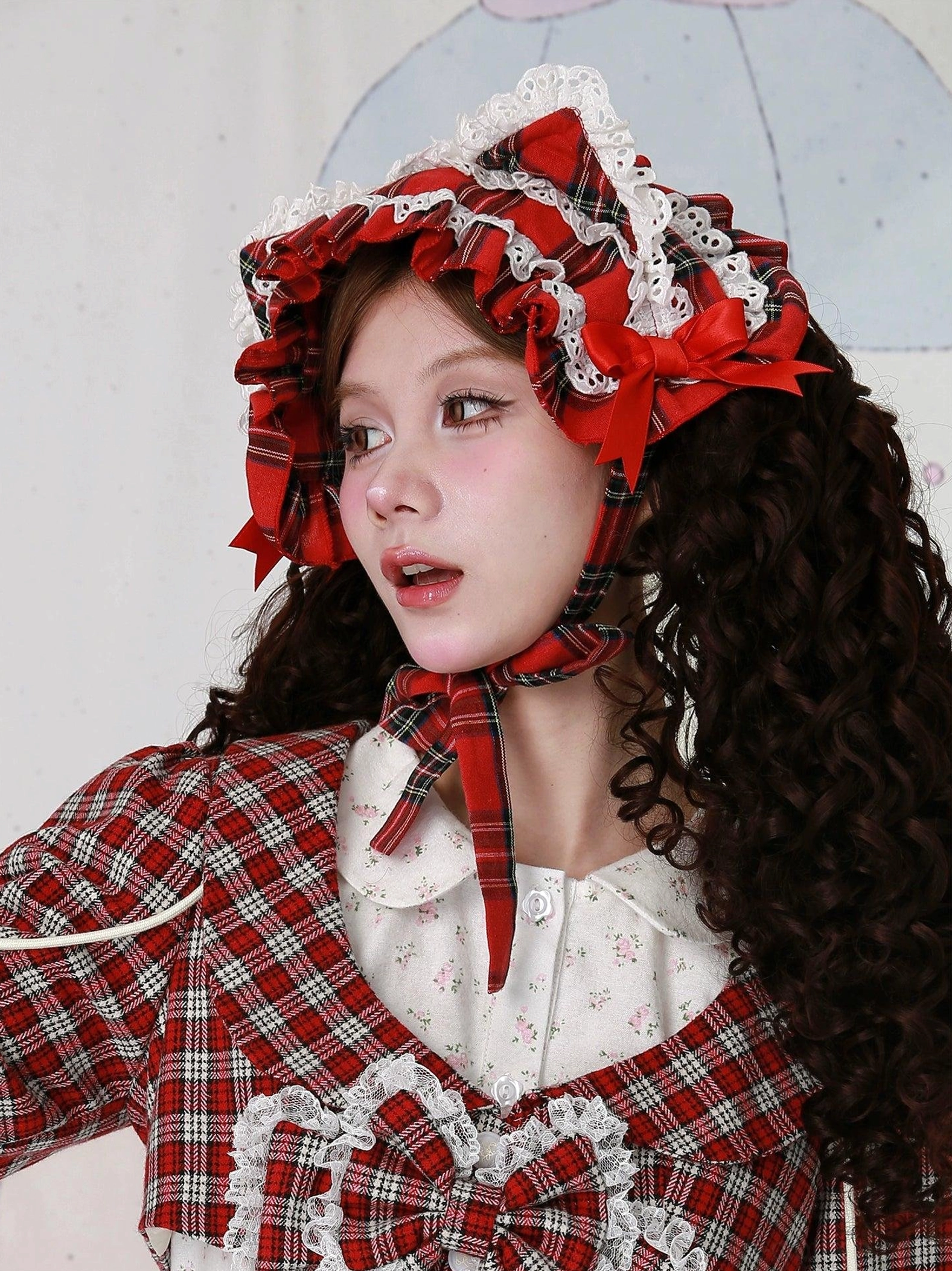 Red tartan plaid cat ear lolita hairband close-up focusing on white ruffled lace edging, red bow placement, and overall aesthetic quality of this sweet lolita hair accessory for headdress enthusiasts
