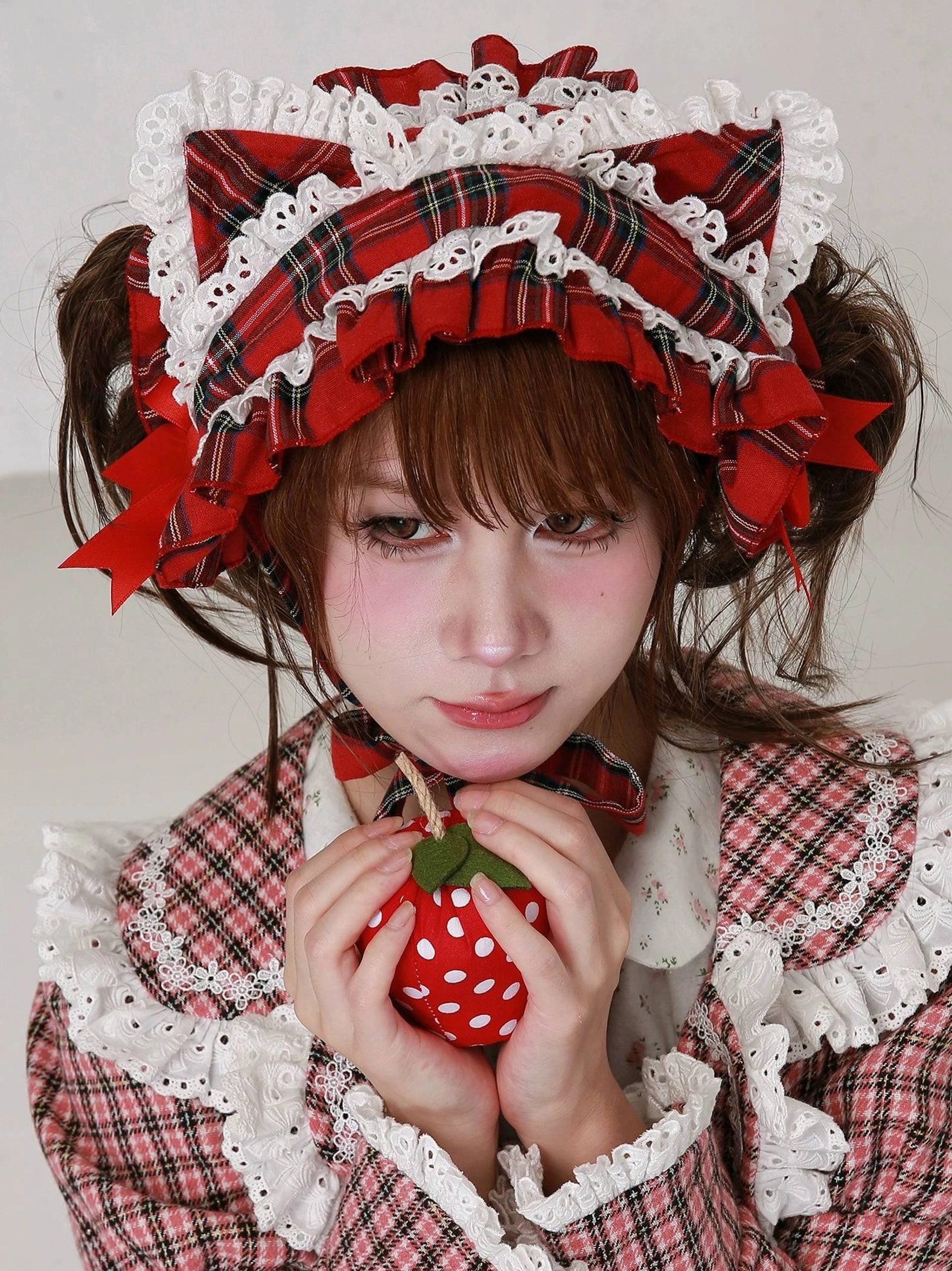 Red plaid cat ear lolita headdress construction detail, showcasing craftsmanship of layered lace trim, structured cat ears, and overall architectural design of this sweet lolita hair accessory
