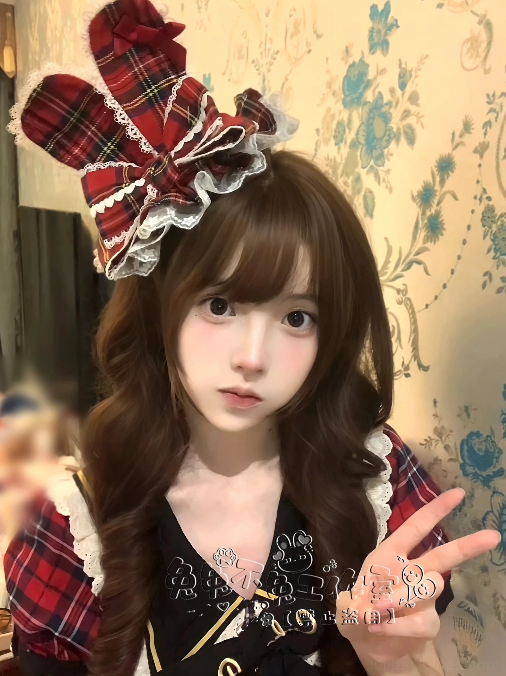 Close-up front view of model wearing red plaid Lolita bunny ear hair bow with lace ruffle trim rabbit ear bow shape paired with matching red plaid Lolita fashion outfit
