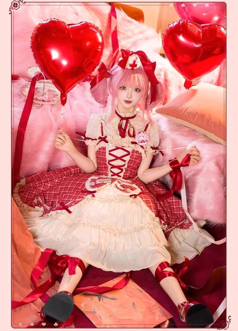 Full-body front lying down view of model in red plaid lolita cake jumper skirt dress on pink plush bed with heart foil balloons, clear view of lace-up front bodice