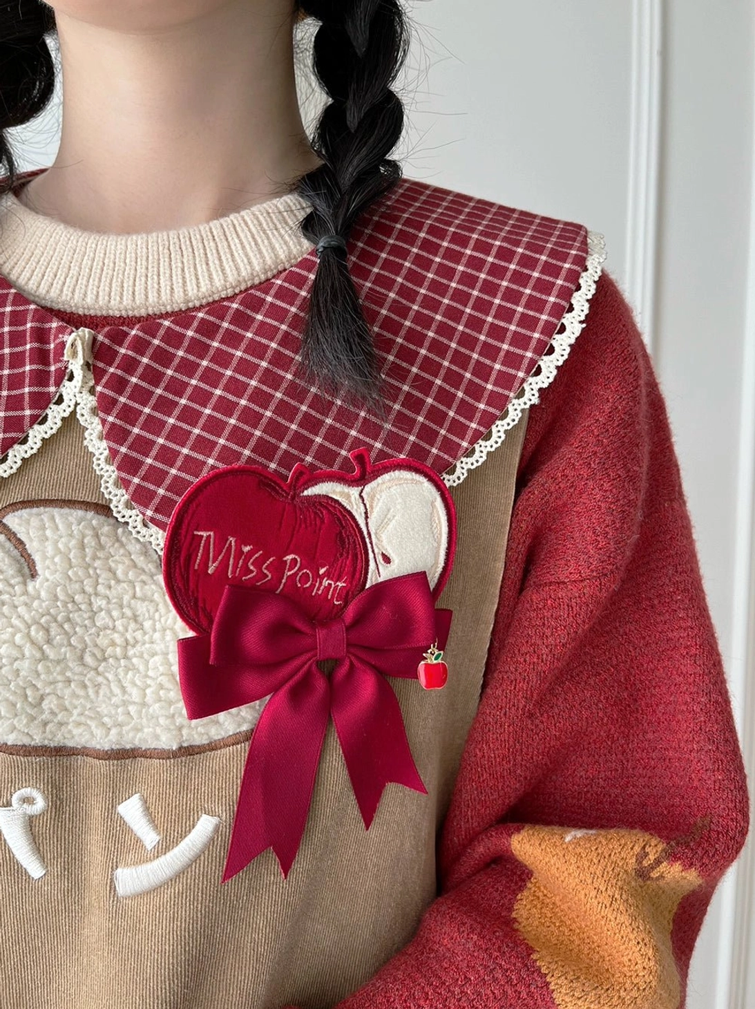 Red plaid peter pan lolita collar with lace trim worn on model neck-up close-up view large miss point bow brooch apple ornament styling