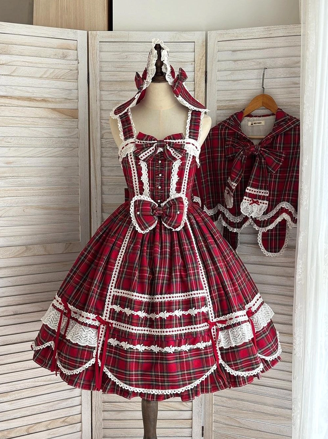 Red tartan lolita JSK dress matching detachable plaid shawl capelet front static dress form display scalloped white lace skirt hem front waist bow shoulder straps white lace trim hidden side pockets design feature