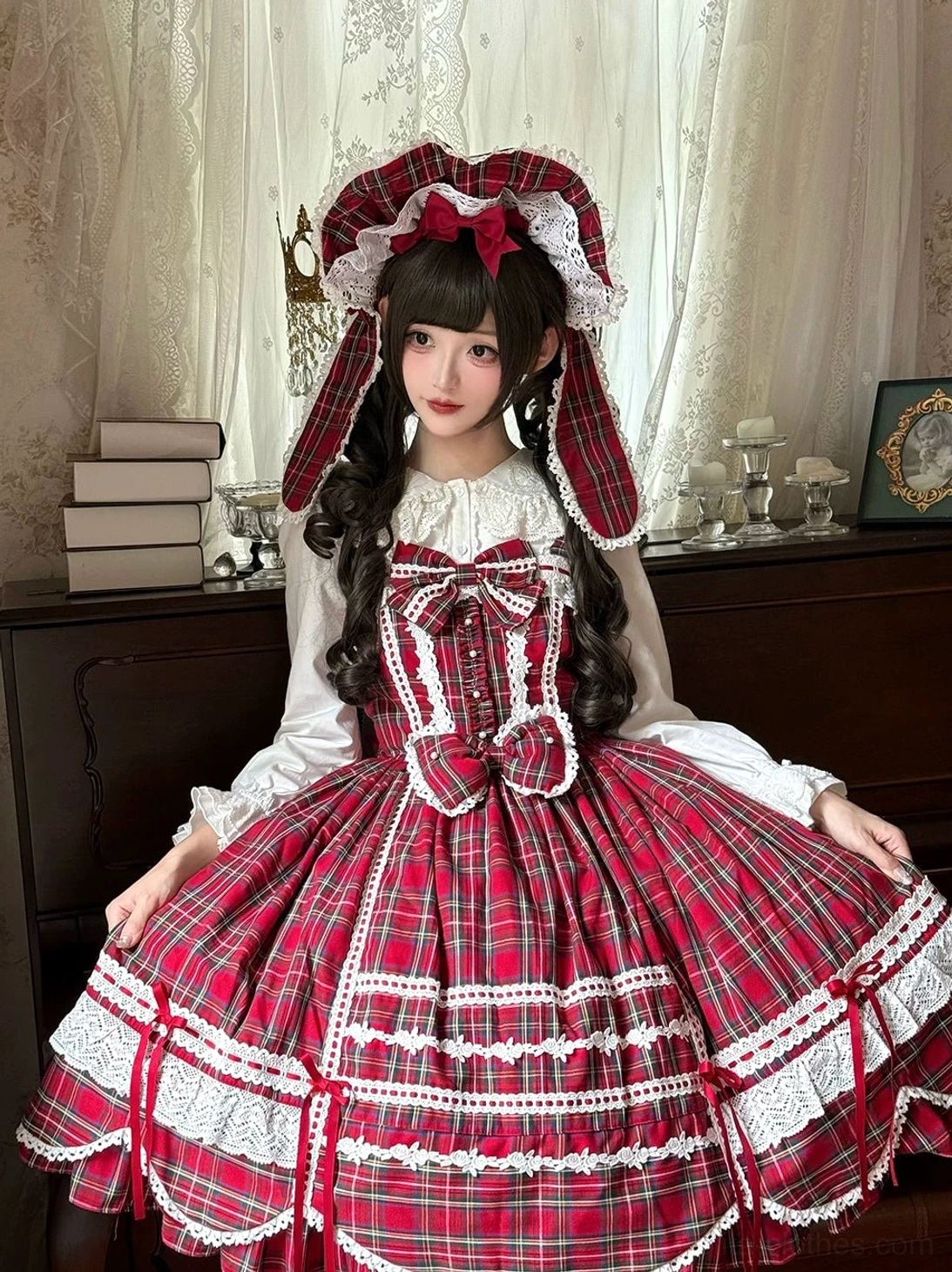 Red tartan old school lolita JSK dress matching rabbit ear bonnet front three-quarter close-up portrait lolita model vintage bedroom white ruffled blouse big chest bow layered lace trims voluminous plaid skirt detail