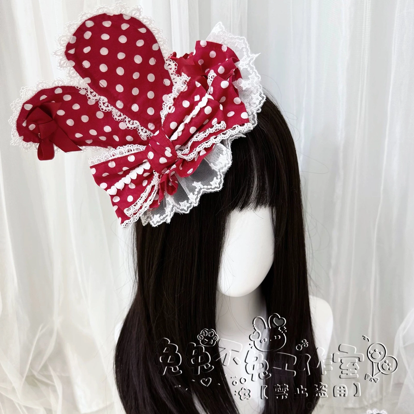 Red polka dot Lolita bunny ear hair bow clip front view on blank mannequin head featuring white polka dot print lace ruffle edge and large rabbit ear bow shape