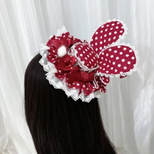 Red polka dot Lolita bunny ear hair clip worn on mannequin showing white polka dot pattern, delicate lace ruffle edge, ribbon bow and fluffy pom-pom embellishments back view