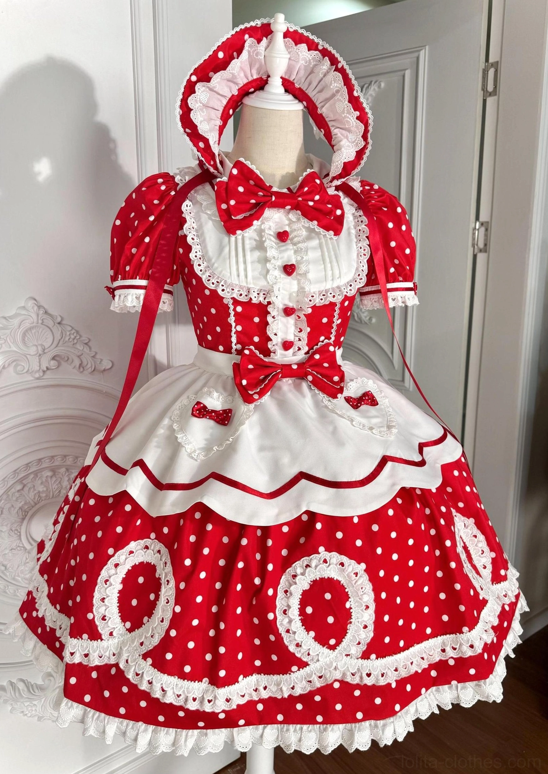 Red polka dot old school lolita OP dress with detachable apron and matching bonnet displayed on dress form front view