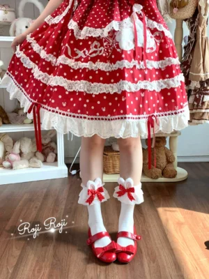 Red accent sweet lolita socks worn on model with red polka dot frilled lolita skirt red Mary Jane shoes bunny ear lace trim back view