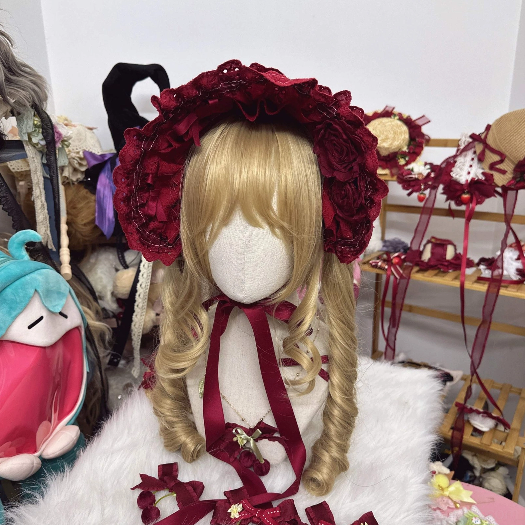 wine red rose lolita cotton bonnet close-up display showing ruffled lace and tied chin straps detail