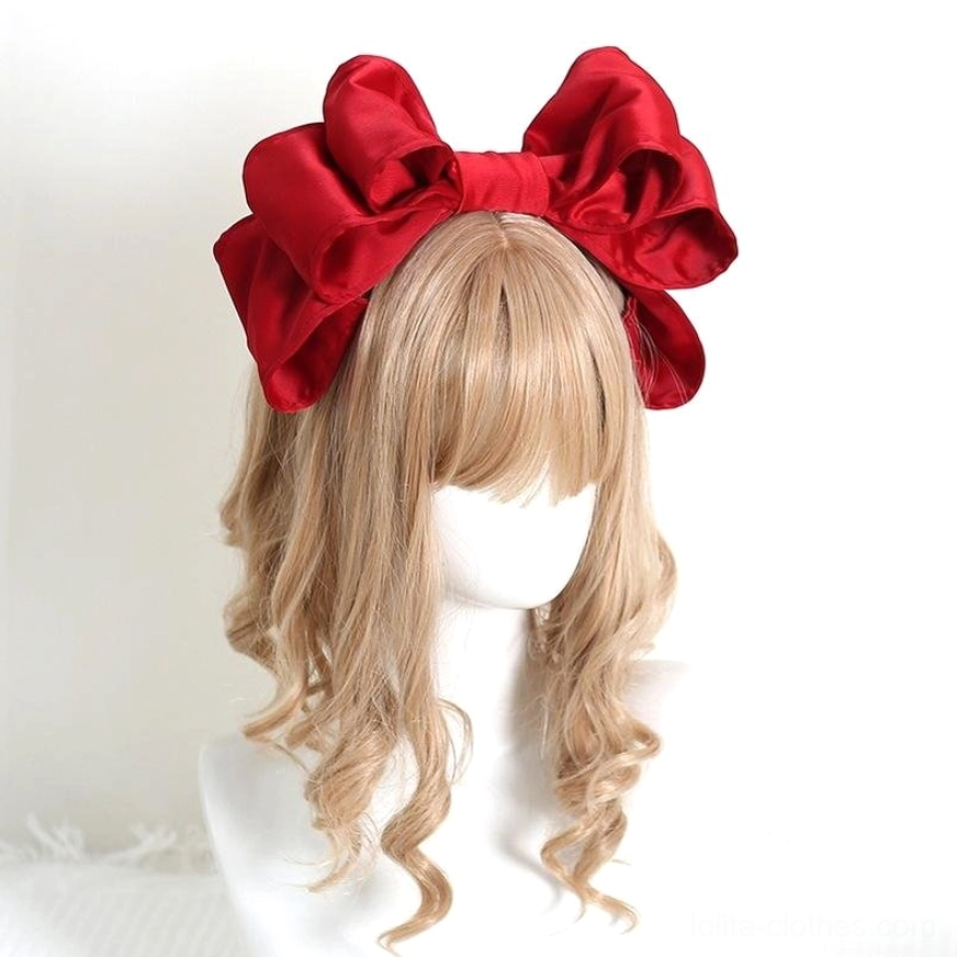 Bright red glossy satin layered bow Lolita hair clip KC with 3D voluminous design on mannequin with blonde curly wig front view
