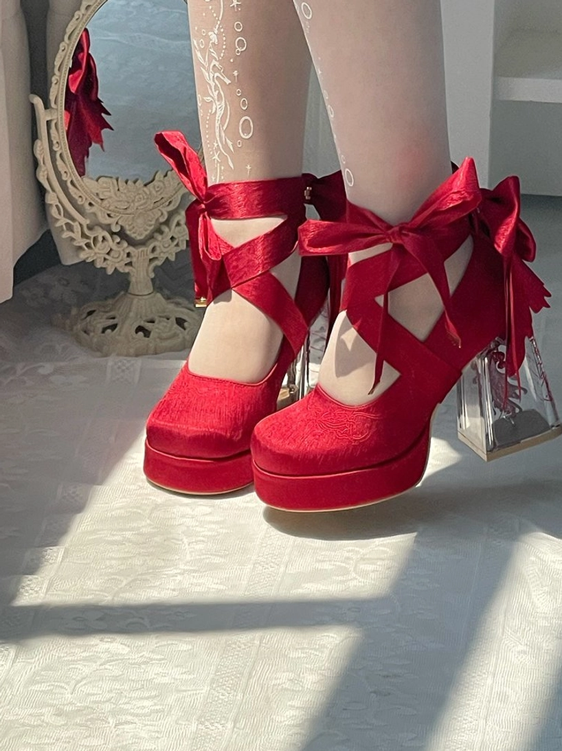 Red satin classic lolita platform heels overhead view with cross ankle straps ribbon bows and white floral stockings