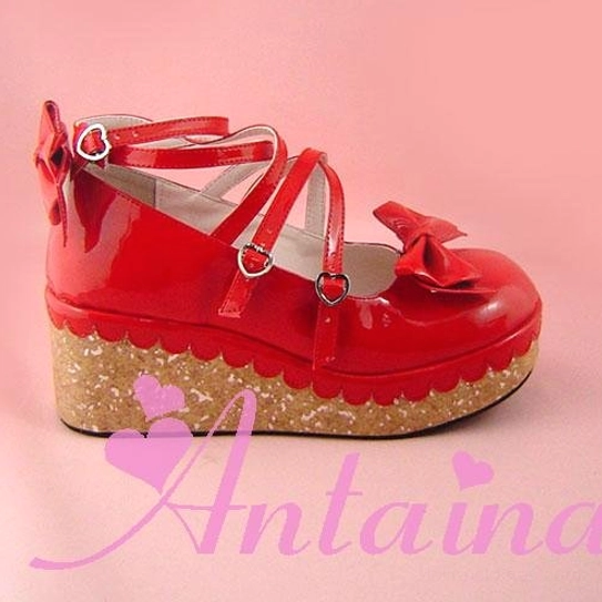Red shining Lolita platform shoes with double color sole combining glossy red upper, contrasting platform sole, toe and heel bow decorations, and heart-shaped ankle buckles