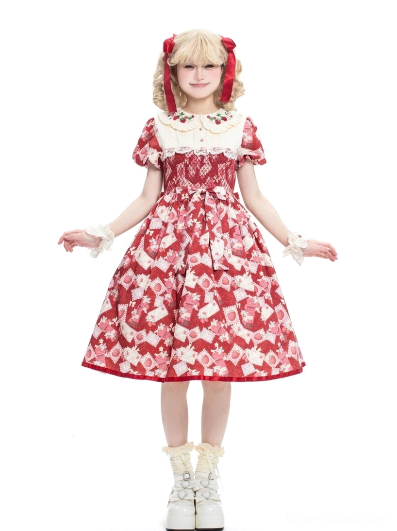 Red strawberry Lolita OP dress full-body front view highlighting high-waisted A-line skirt, shirred bodice, puff short sleeves with ruffled edges, model with blonde twin tails red bows and white platform boots