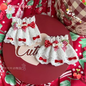 Red strawberry Lolita wrist cuffs pair featuring white hollow lace with red gingham and red polka dot bows and green leaf embellishments on red strawberry printed fabric