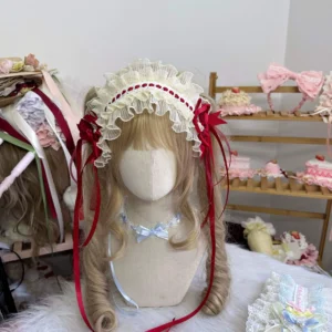 Red sweet lolita headdress with ruffled lace band and large red satin bows displayed on blonde mannequin