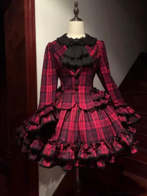 Red tartan plaid old school lolita coat and tiered skirt set with black ruffled trim on dress form