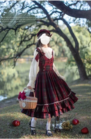 Back three-quarter view of vintage red tartan lolita dress with high-waist JSK, ruffled lace hemline, white frilled blouse collar, and matching tartan beret, woodland lakeside backdrop