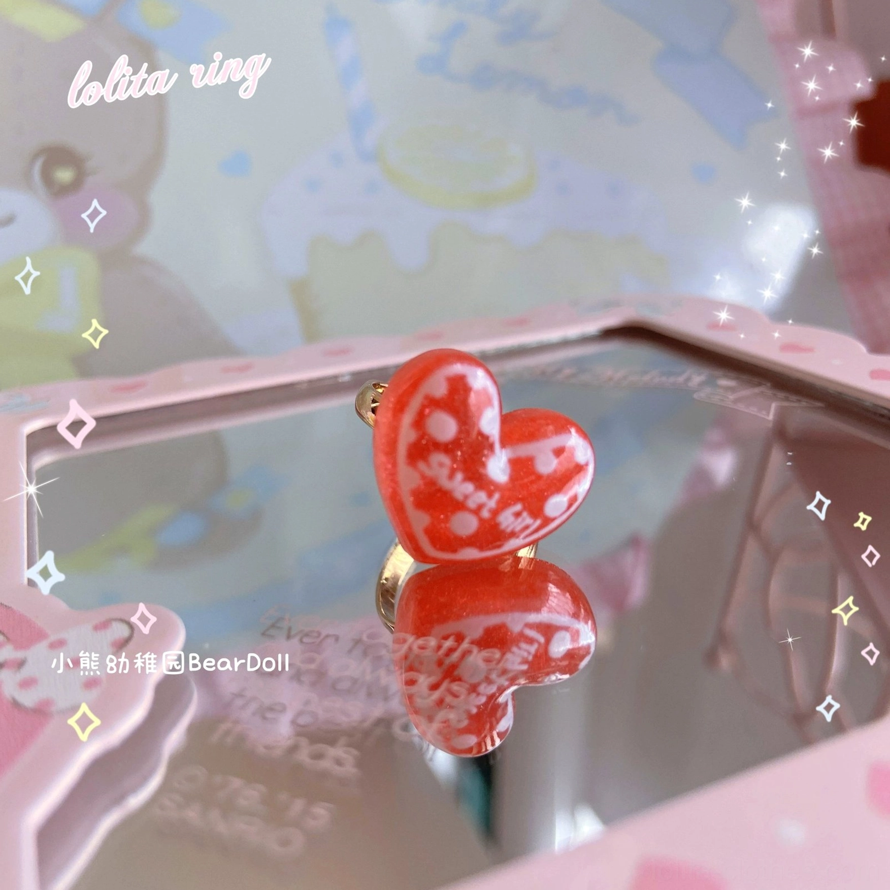 Red transparent resin heart Lolita ring with white printed heart pattern gold metal base close-up