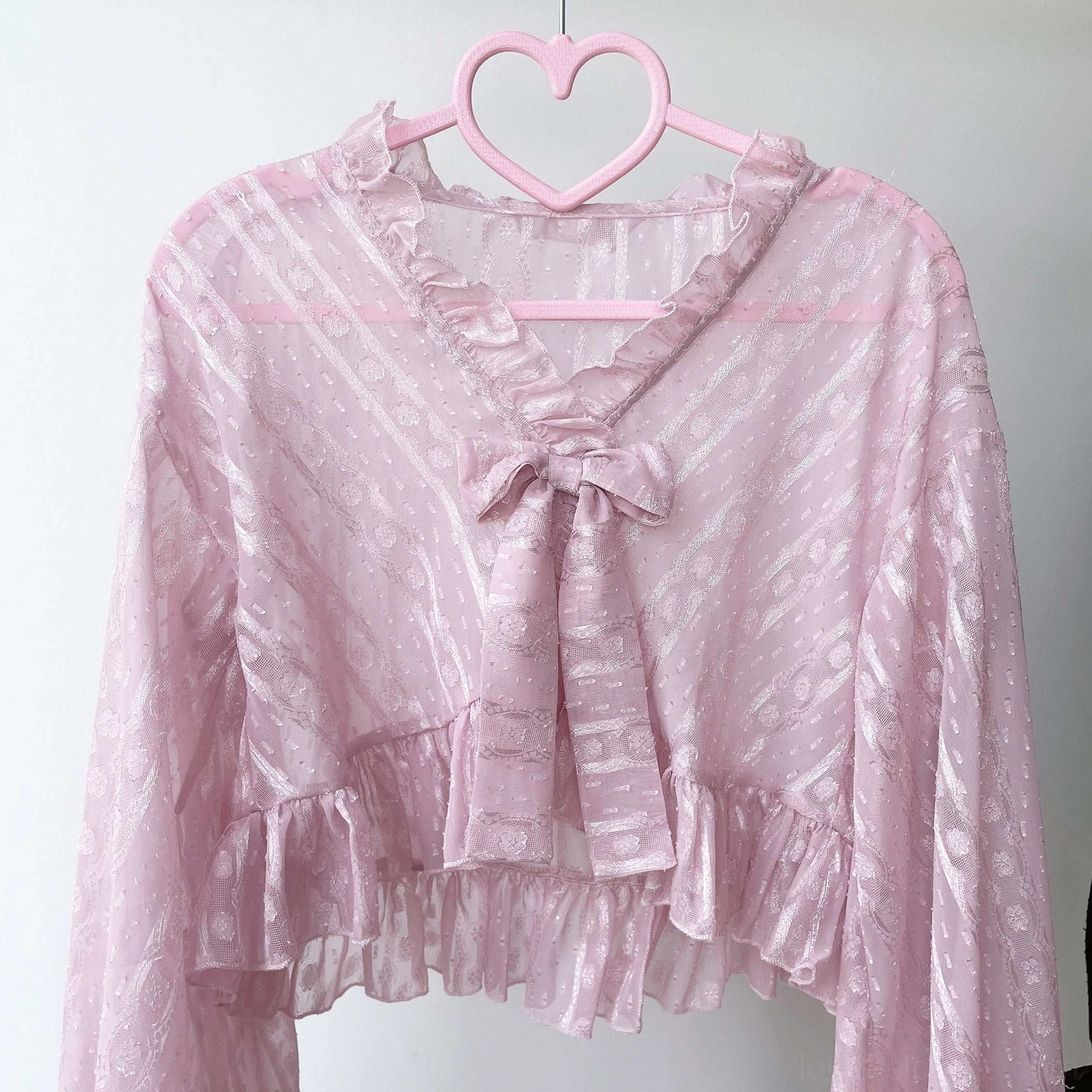 Removable bow accent detail on sweet Lolita chiffon puff sleeve cardigan showing design versatility and customization