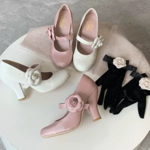 Retro sweet Lolita Mary Jane high heel shoes displayed overhead flat lay view on white round table with matching flower-decorated gloves white and pink colorway patent leather rose flower strap