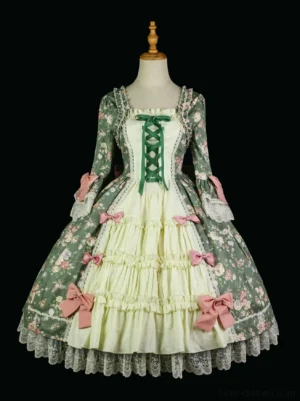 Classic Rococo floral print lolita one-piece OP dress front view with square neckline, green fabric, pink decorative bows, and layered ruffled skirt with lace hem on black mannequin display