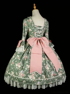 Back view of Rococo floral print classic lolita OP dress showing lace-up back closure, oversized pink scalloped waist bow, tiered ruffled skirt design on dress form without model