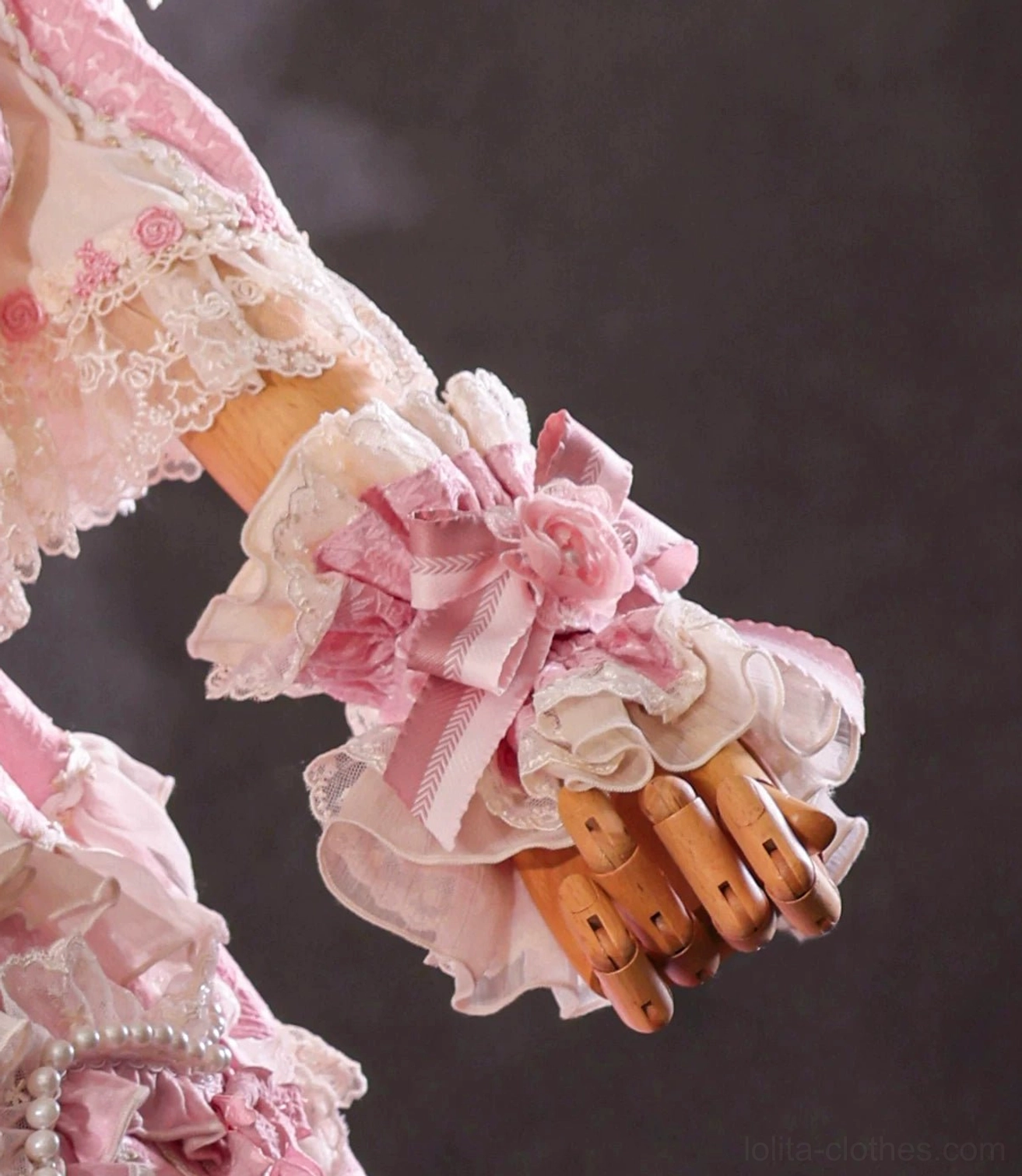 All-pink layered ruffled lolita wrist cuff with big pink satin bow and fabric rose decoration front close-up view