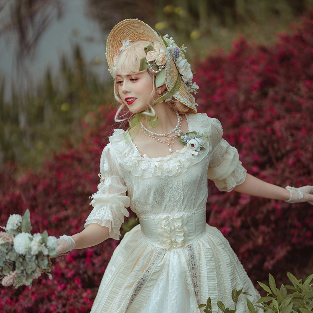 Romantic outdoor lolita portrait three-quarter view with ivory ruffle dress floral decorated straw bonnet pearl necklace and flower bouquet red foliage backdrop