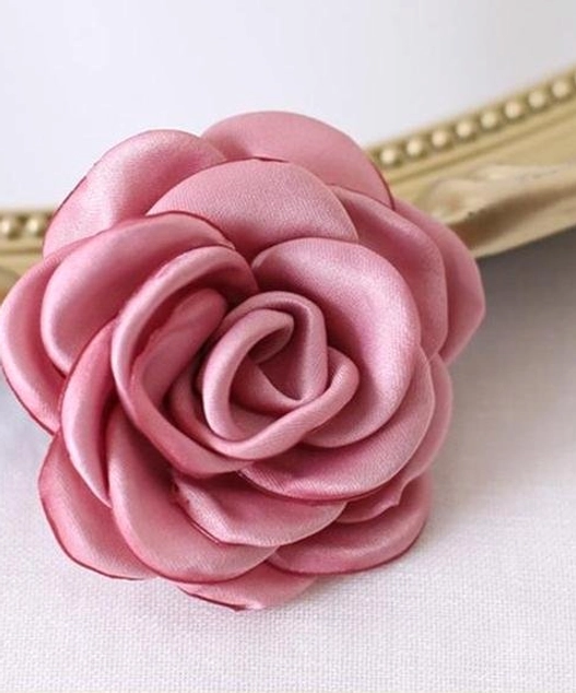 Vintage fabric rose brooch and hair clip accessory detailed construction showing burnt-edge technique and dual backing mechanism