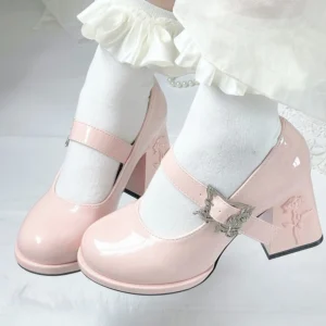 Rose-embossed Mary Jane block heel lolita shoes in light pink patent leather worn with ruffled white socks, featuring silver rose buckle strap and rounded toe silhouette