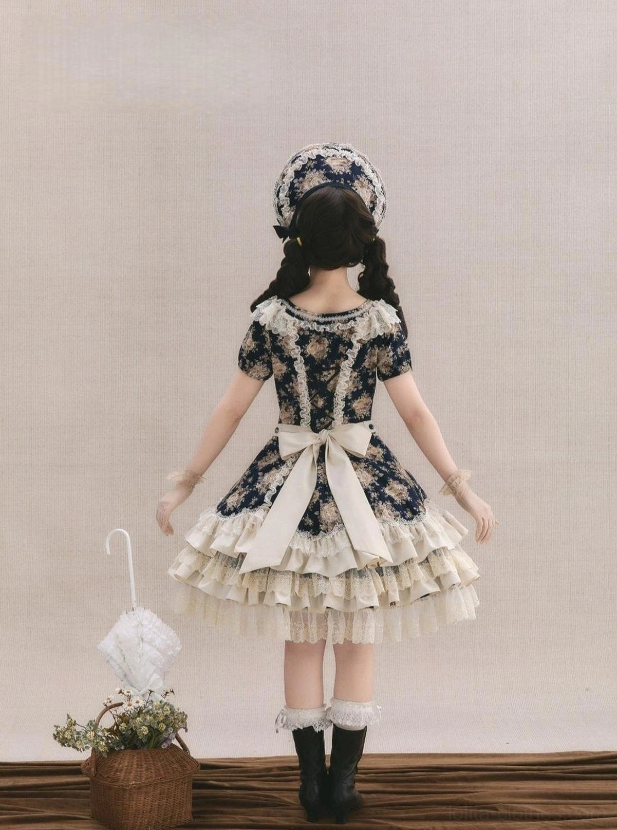 Long-sleeve vintage floral Lolita OP dress back view showing large cream satin bow at waist and tiered lace skirt