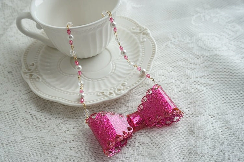 Rose red glittery scalloped resin bow necklace with pearl beaded chain romantic lolita style accessory