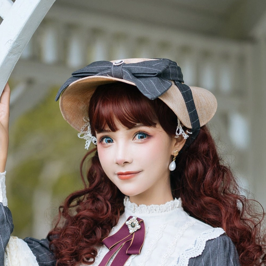 Elegant lolita flat hat with navy blue striped bow and gemstone brooch, frontal close-up portrait of red-haired model with vintage elegant styling, ruffled white collar