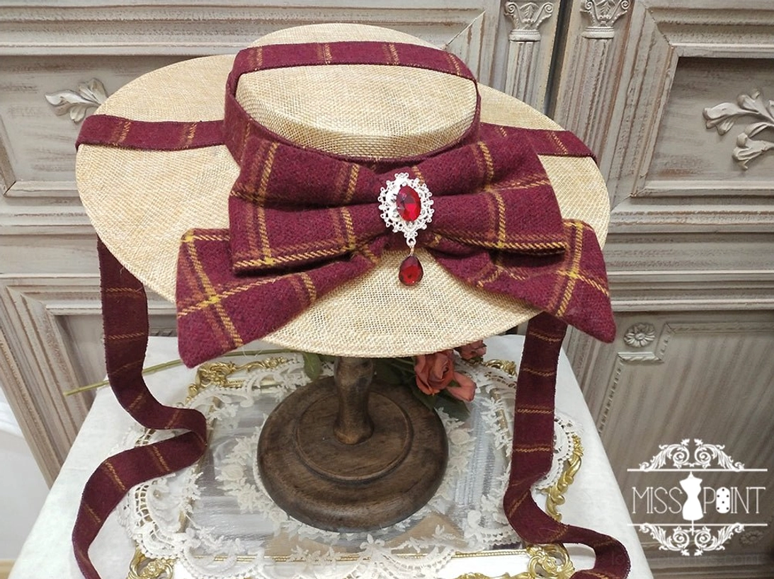 Vintage-inspired lolita flat hat with decorative bow and metal ornaments, three-quarter view emphasizing the iconic headdress silhouette and elegant proportions