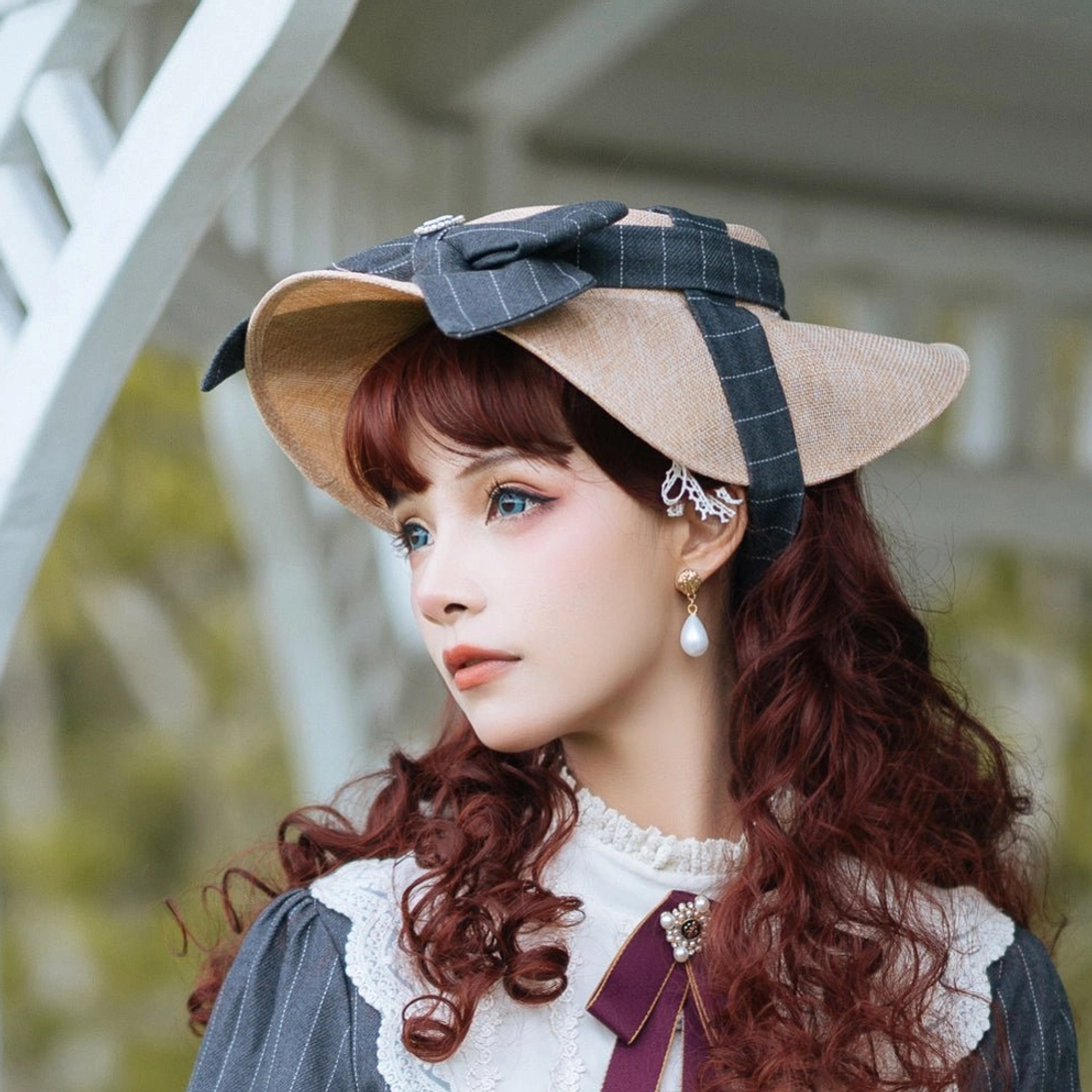 Elegant lolita headdress with striped bow pattern and decorative gemstone, side angle view displaying the structured flat brim and ornamental bow apex