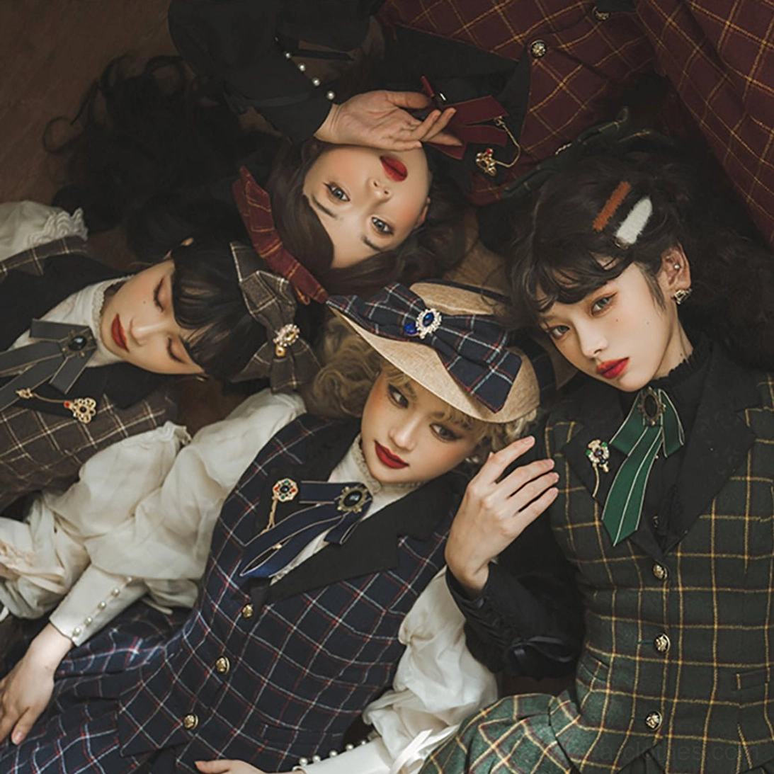 Multiple coordinated lolita flat hats in different plaid patterns and colors, group overhead shot of four female models lying together in vintage interior, matching hat and dress combinations
