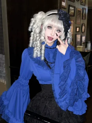 Royal blue Gothic Lolita Hime-sleeve blouse with delicate lace ruffled trumpet sleeves, standing collar, and vintage-style buttons, styled with black lace skirt and gothic hair accessories