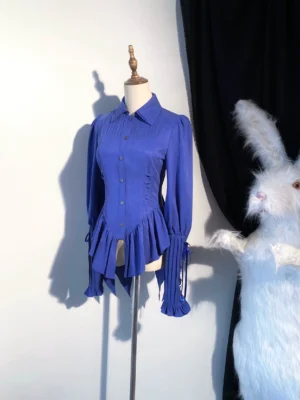 Royal blue Gothic Lolita mutton sleeve blouse with swallow tail hem displayed on dress form featuring double-layered lapel collar accordion pleats and asymmetrical hem