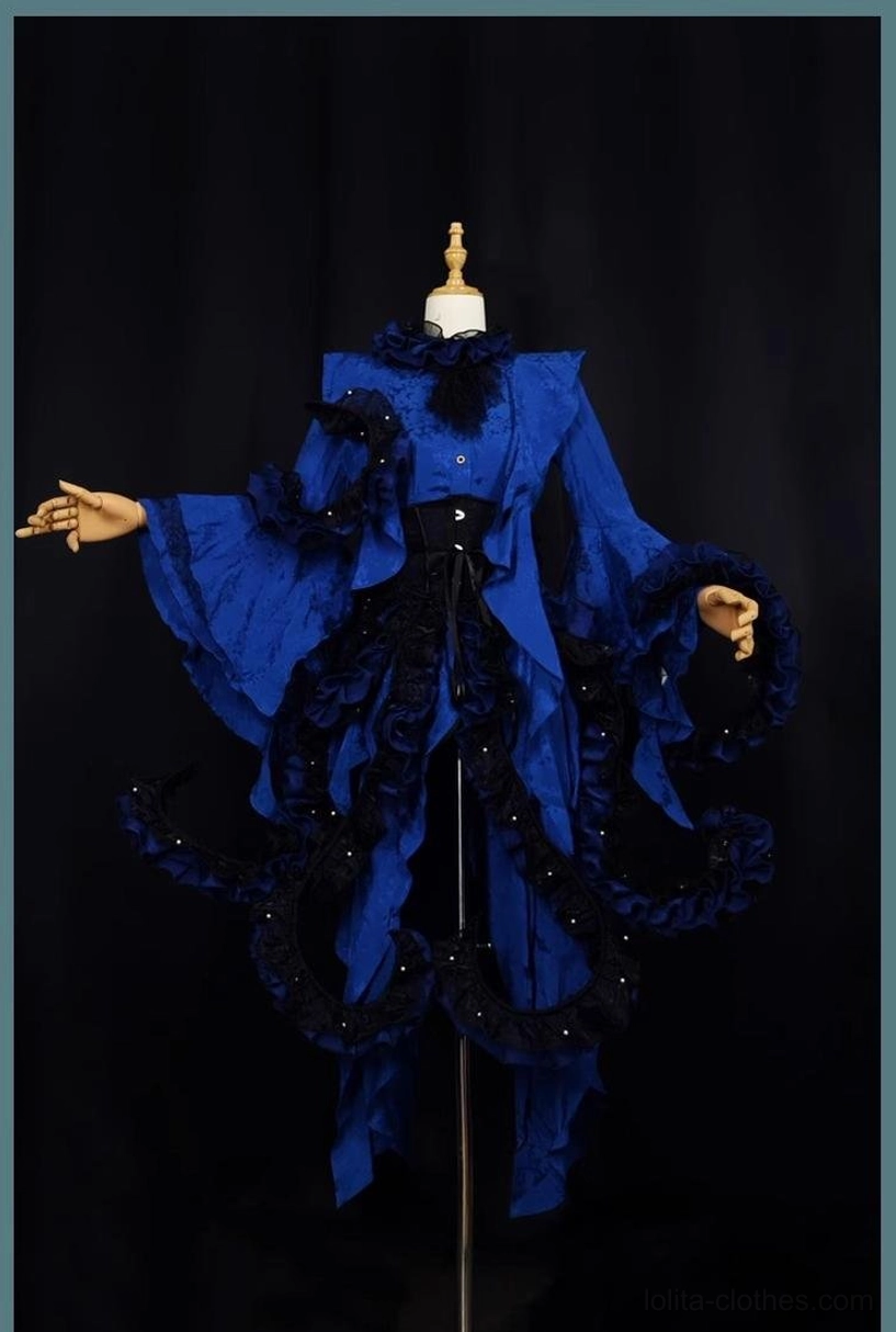 Royal blue gothic Ouji Lolita outfit on dress form showing dark tentacle-style ruffled hem decorations, attached black corset waist detail, feathered neck accessory, flared princess sleeves