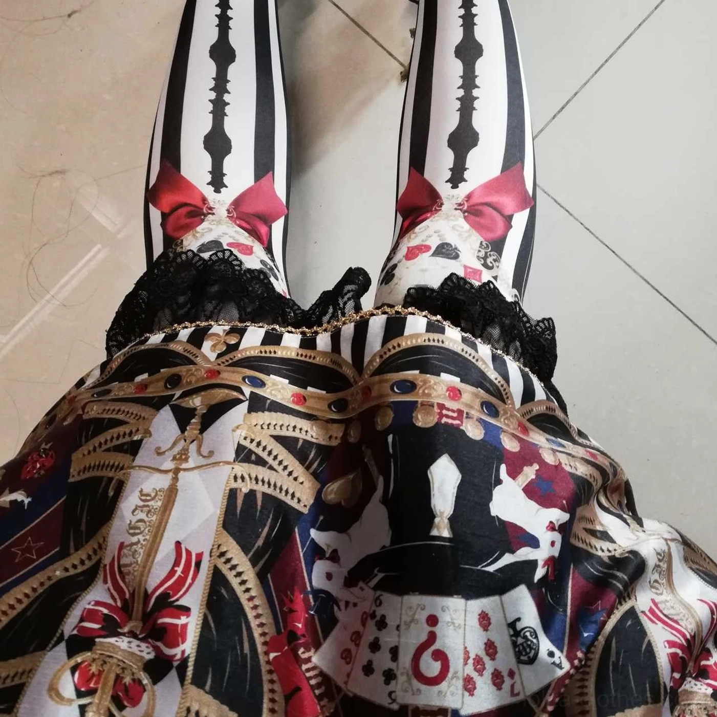 Detailed overhead view of Royalty Game Chessboard Lolita Tights with chessboard patterns, red bow accents and playing card themed printed design elements
